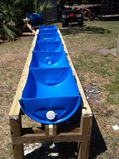 an upside down blue boat sitting on top of a wooden bench