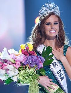 a woman in a tiara is holding flowers