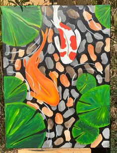 a painting of a koi fish and green leaves