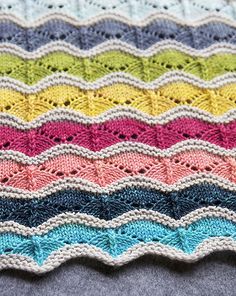 a multicolored crocheted blanket on top of a table