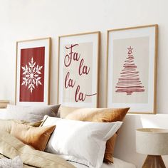 three framed pictures hang on the wall above a bed with white sheets and beige pillows