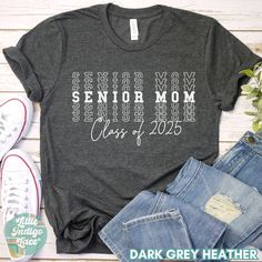 a t - shirt with the words senior mom class of 2020 printed on it next to jeans and sneakers