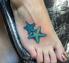 a foot tattoo with three starfishs on it's side and one in the middle