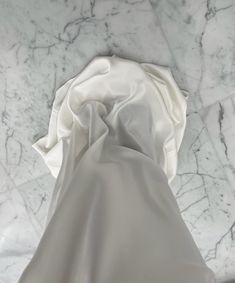 a white cloth laying on top of a marble floor