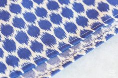 blue and white patterned fabric is folded on top of each other