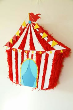 a red and white circus tent hanging from the ceiling