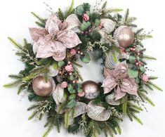 a christmas wreath with pink and green decorations