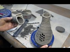 someone is making a vase out of clay on a workbench with other tools