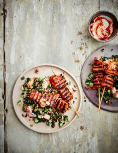 two plates filled with food on top of a wooden table