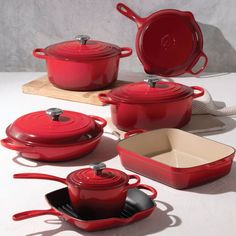 red pots and pans on a white table