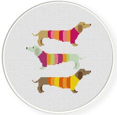 two dachshunds in sweaters cross stitch pattern on a white circle frame