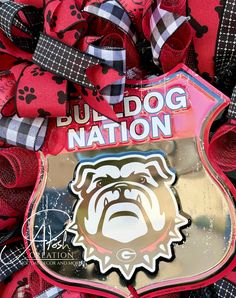 a close up of a red and black wreath with the bulldog nation logo on it