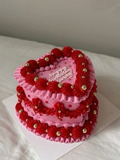 a heart shaped cake on top of a white sheet