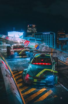 two cars driving down the road in front of each other on a city street at night