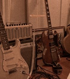 guitars and amps are lined up on the floor