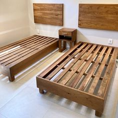 a bed frame made out of wooden slats in a room with white tile flooring