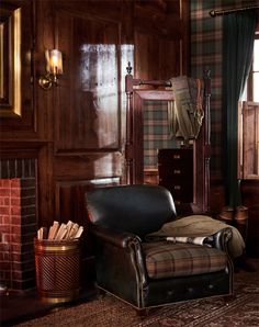 a chair and mirror in a room with wood paneling on the walls, plaid carpet