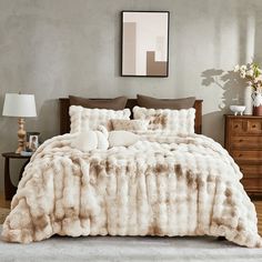 a bedroom with a bed covered in white fur