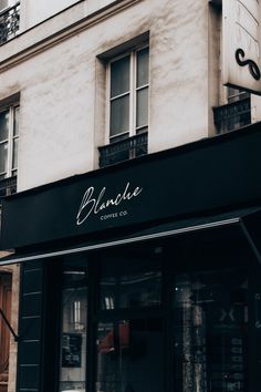 a black and white photo of a coffee shop