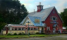 an old train station with a red building