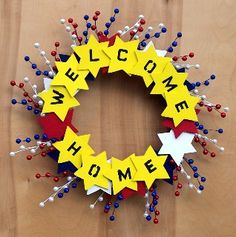 a welcome home wreath made out of paper stars