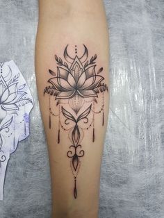 a woman's leg with a lotus tattoo on it