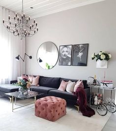 a living room filled with furniture and a chandelier