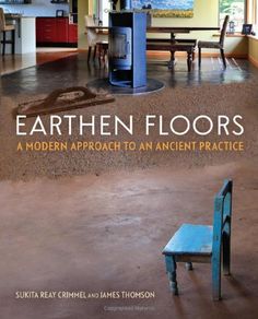 a blue chair sitting on top of a dirt floor next to an open doorway with people in the background