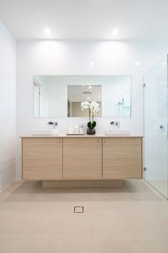 a bathroom with two sinks and a large mirror