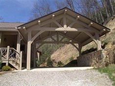 a large wooden structure sitting on the side of a hill next to a building with stairs leading up to it