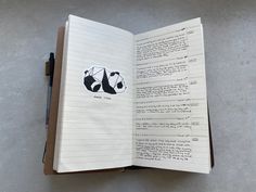 an open notebook with panda stickers on it's side and writing in the middle