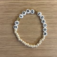 a white beaded bracelet with the words london on it