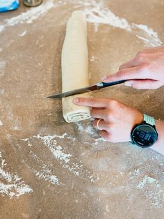 a person using a pair of scissors to cut dough