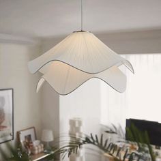 a white lamp hanging from the ceiling in a living room