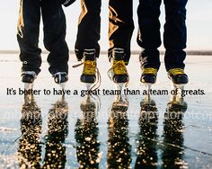 three people standing in the rain with their feet up