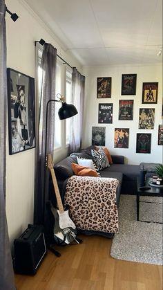 a living room filled with furniture and lots of pictures on the wall next to a window