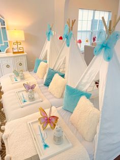 a room with several teepees and pillows on the bed