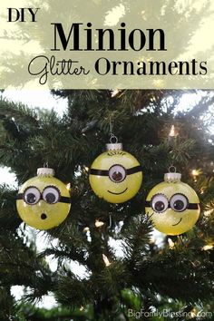 an ornament hanging from a christmas tree with the words diy minion glitter ornaments