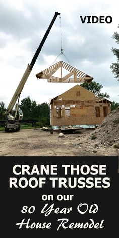 a crane is lifting up the roof on a house