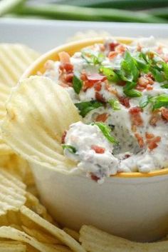 a white bowl filled with dip and chips