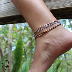 Add a little sparkle to your summer look with our boho-inspired anklet set. This set features three adjustable anklets in versatile shades of gray, brown, and gold. The gray anklet is adorned with small silver beads, while the brown and gold anklets are embellished with shimmering gold beads. Perfect for adding a touch of bohemian charm to any outfit, wear them individually or stack them up for a truly unique look. Get ready to step up your style game and channel your inner free-spirit with this chic and versatile anklet set. Each anklet opens up to 13" Gold Anklet, Shades Of Gray, Beaded Anklets, Couple Bracelets, Anklet Bracelet, Summer Look, Matching Bracelets, The Gray, Braided Bracelets