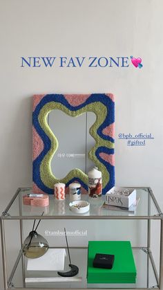 a table with a mirror and other items on it in front of a sign that says new fav zone