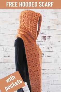 a crocheted hooded scarf is shown in front of a brick wall