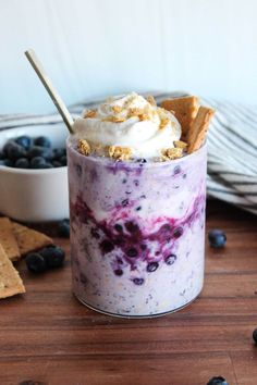 blueberry cheesecake parfait in a glass with graham crackers on the side