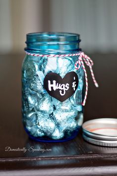 a jar filled with blue candy sitting on top of a table