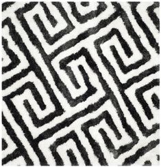 a black and white rug with an abstract design