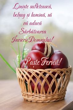 a basket filled with red eggs on top of a wooden table