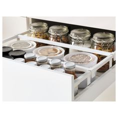 an open drawer with spices and condiments in it