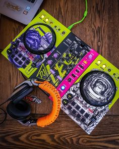 a pair of headphones sitting on top of a table next to an electronic device