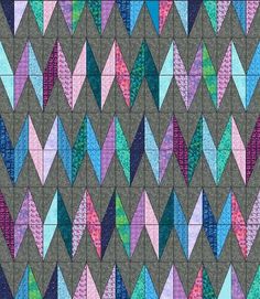 an image of a quilt with many different colored triangles on the front and back side